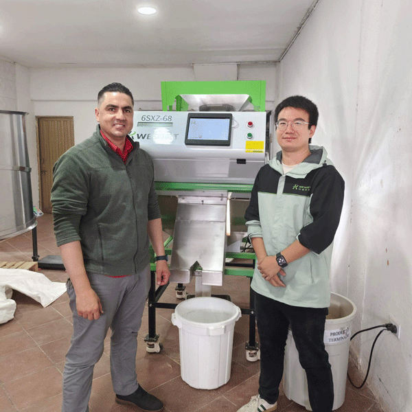 Miguel Suarez with the WESORT color sorter at the Colombian quinoa processing site.