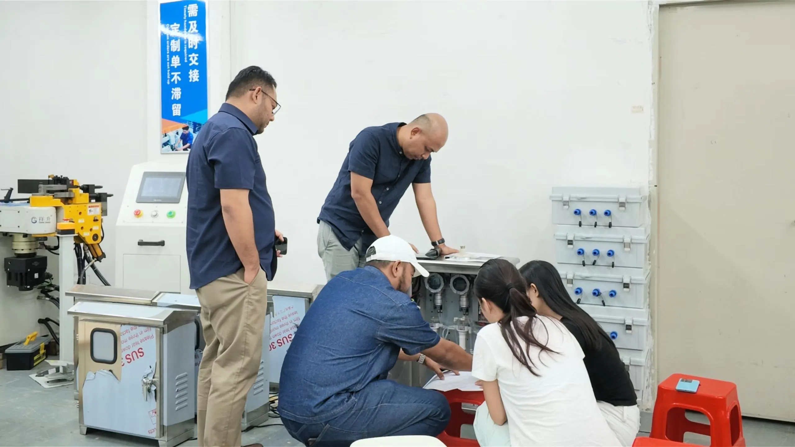 Malaysian clients inspecting the internal pipelines of a large-scale online gas monitoring cabinet at the factory