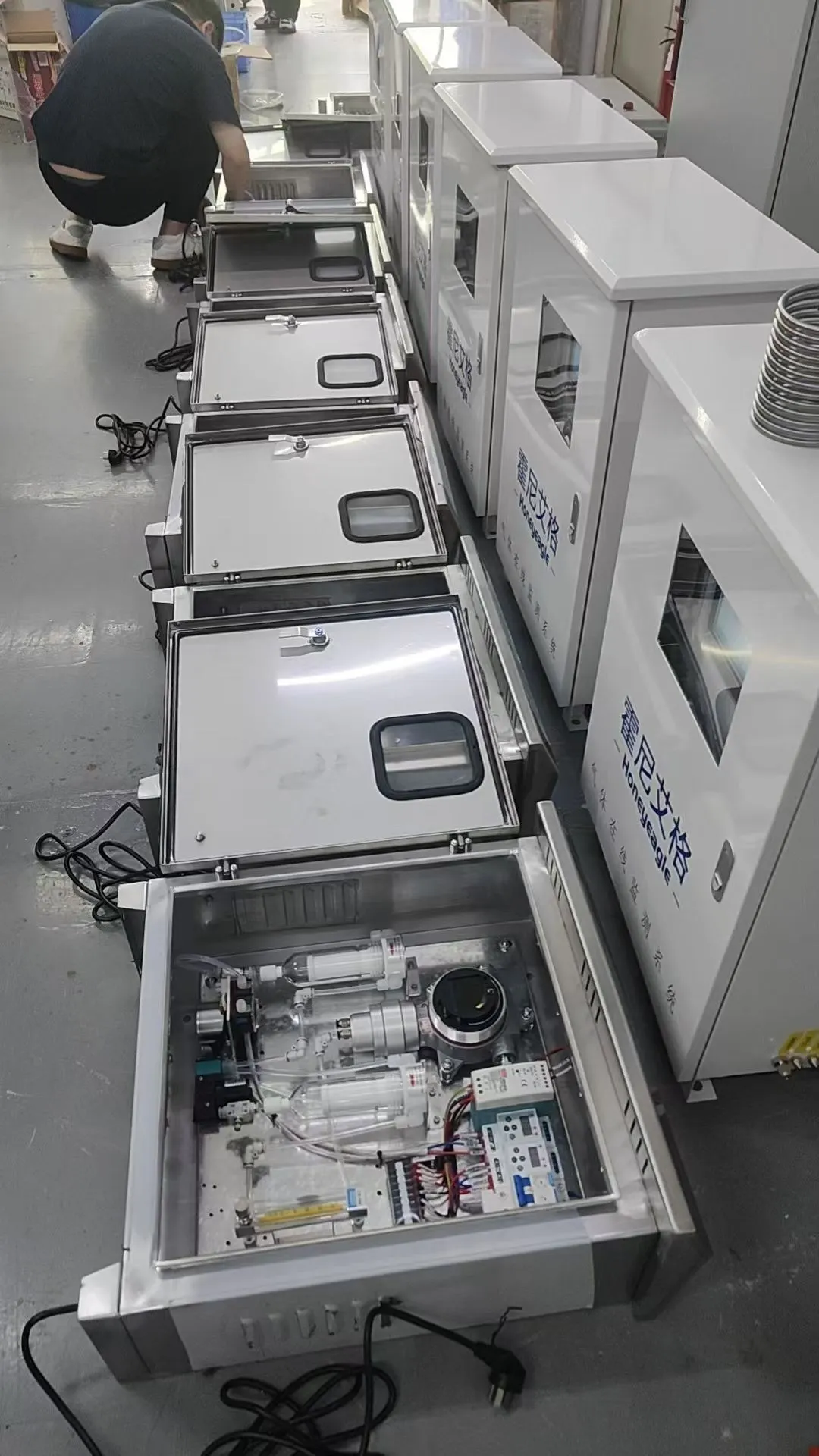 Batch of HNAG6000-VOC Online VOC Monitoring System cabinets undergoing factory assembly