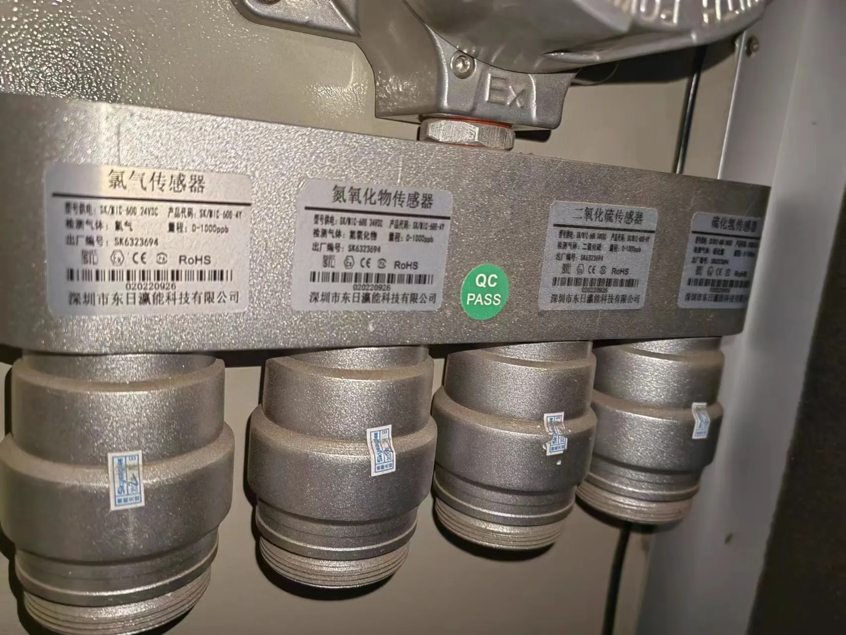Bottom view of the explosion-proof gas monitor showing multiple custom sensor modules for Cl2, NOx, SO2, and H2S