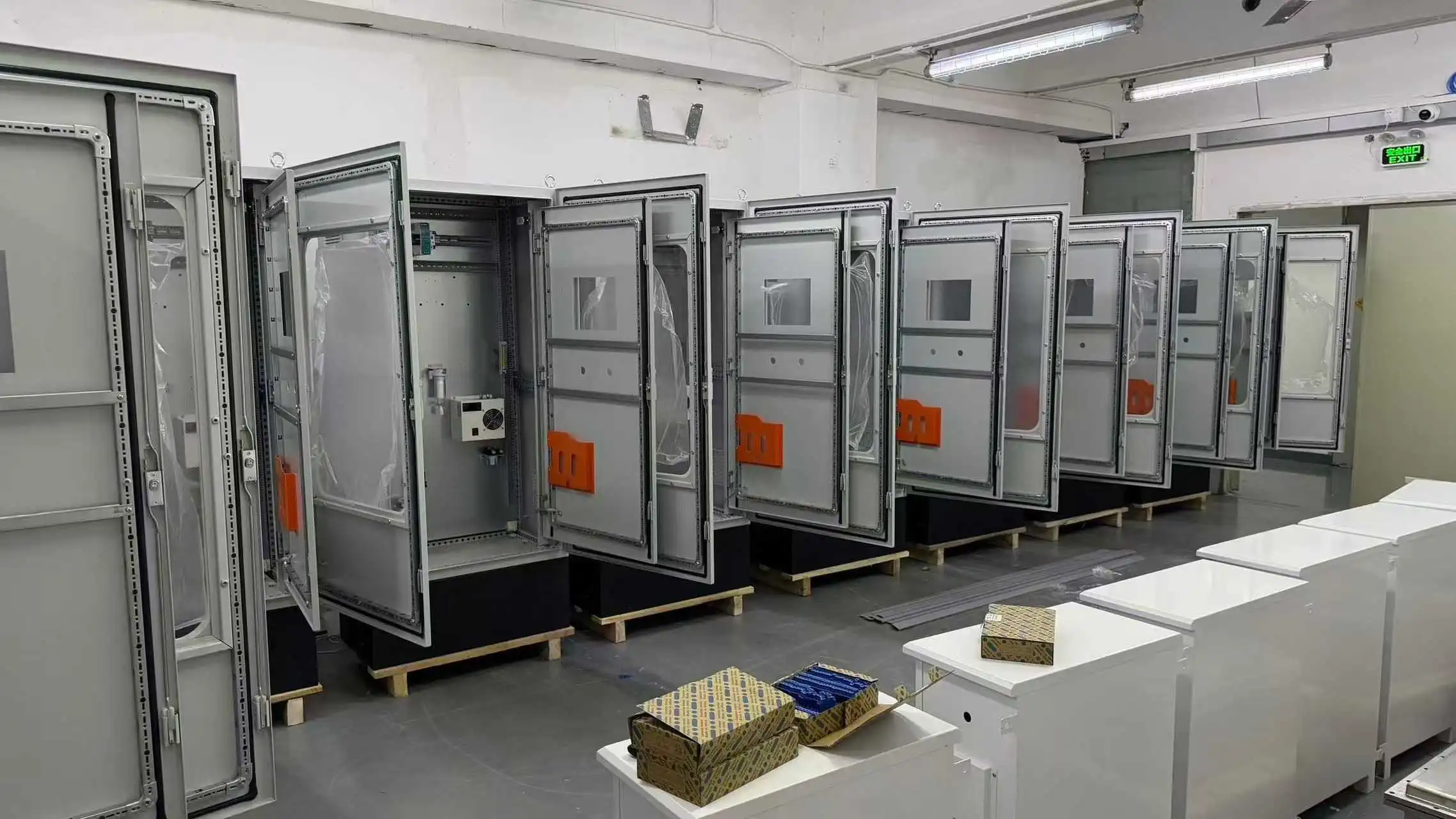 Row of open HNAG1000 Continuous Emission Monitoring System cabinets undergoing internal wiring in the Skyeaglee factory