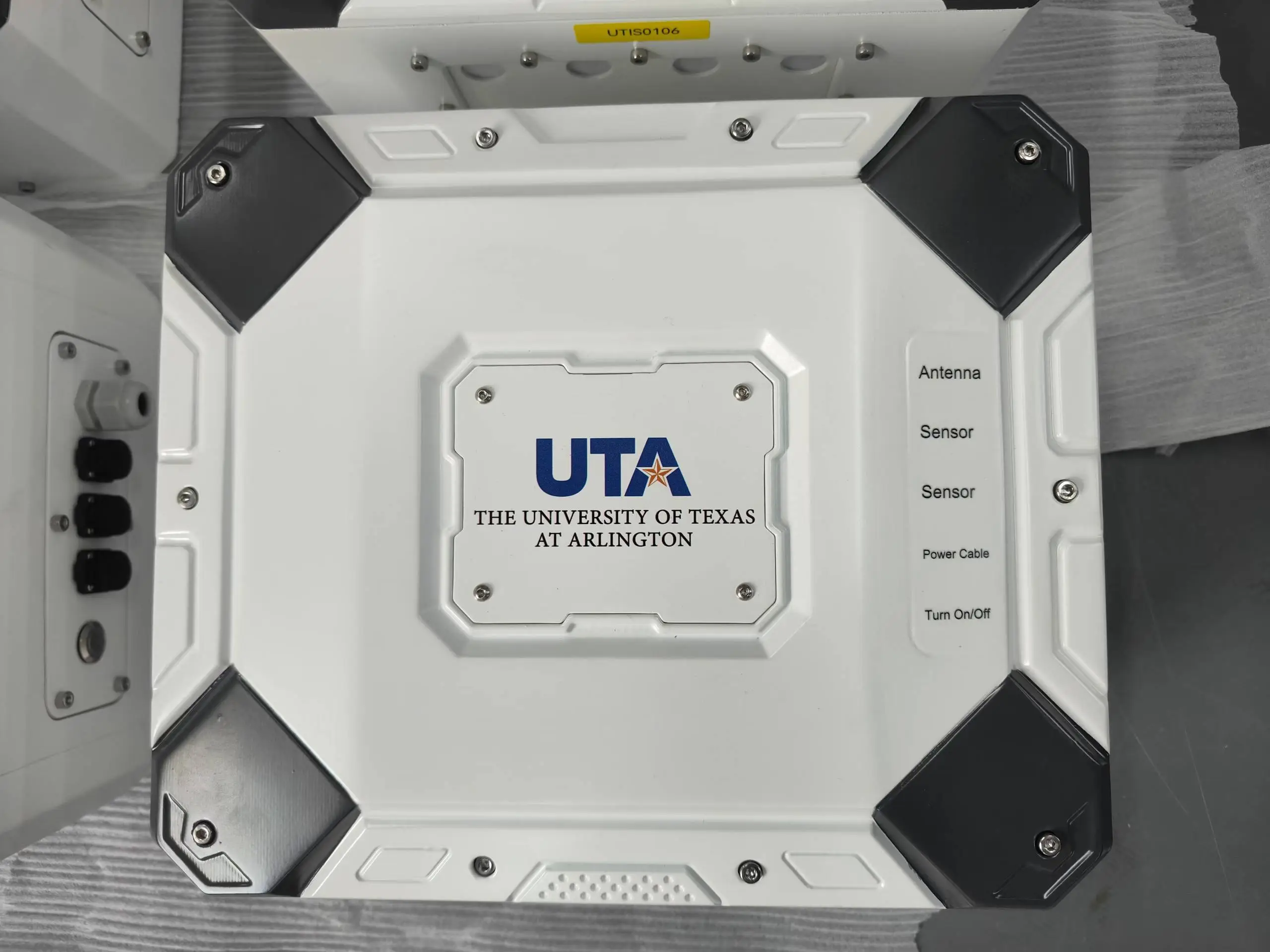 Close-up of the Custom Environmental Monitoring Station featuring the UTA university logo and custom sensor ports