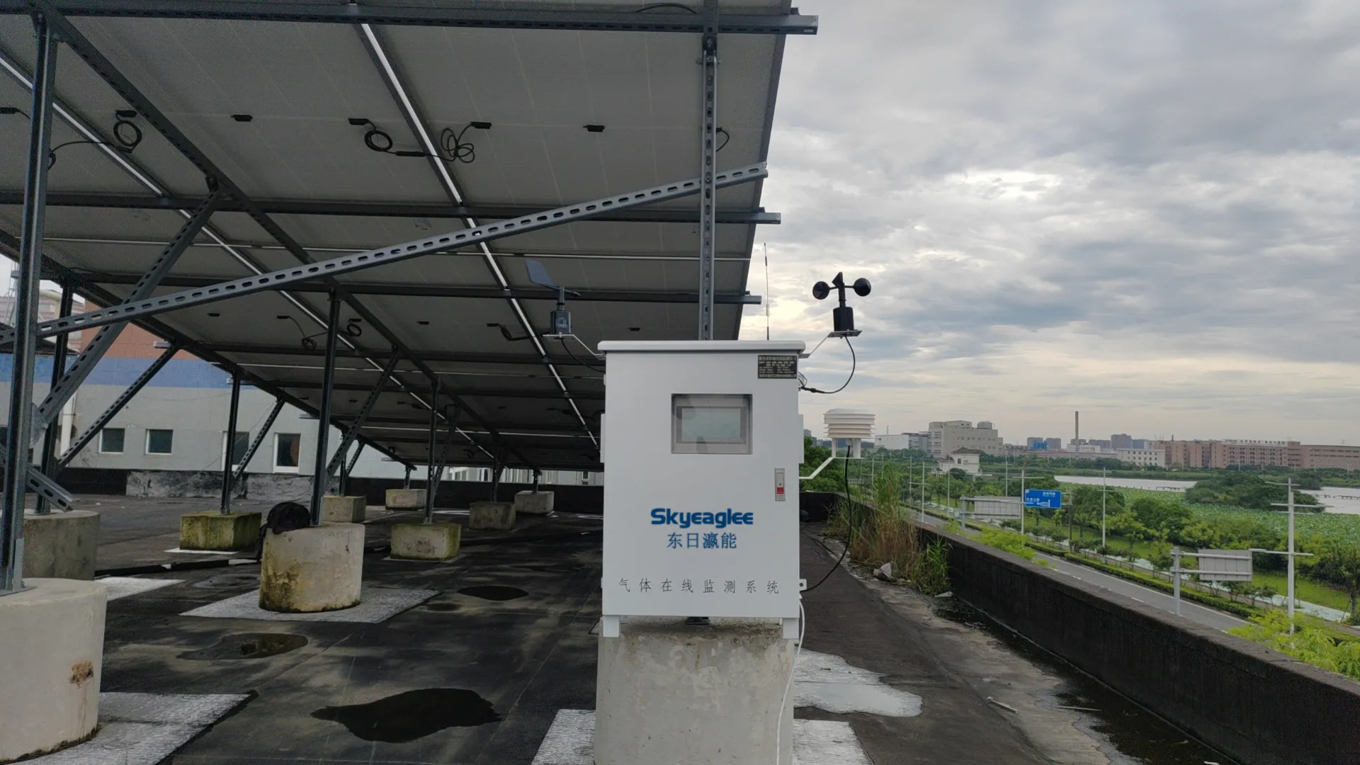 Skyeaglee outdoor gas monitoring system with weather sensors installed on an industrial rooftop with solar panels