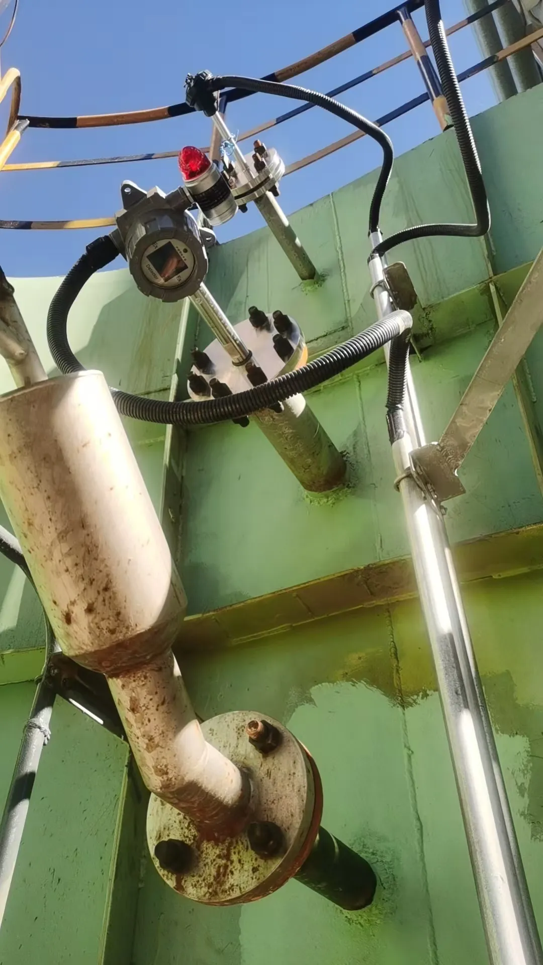 Flange-Mounted Dust Monitor installed on an outdoor industrial silo wall