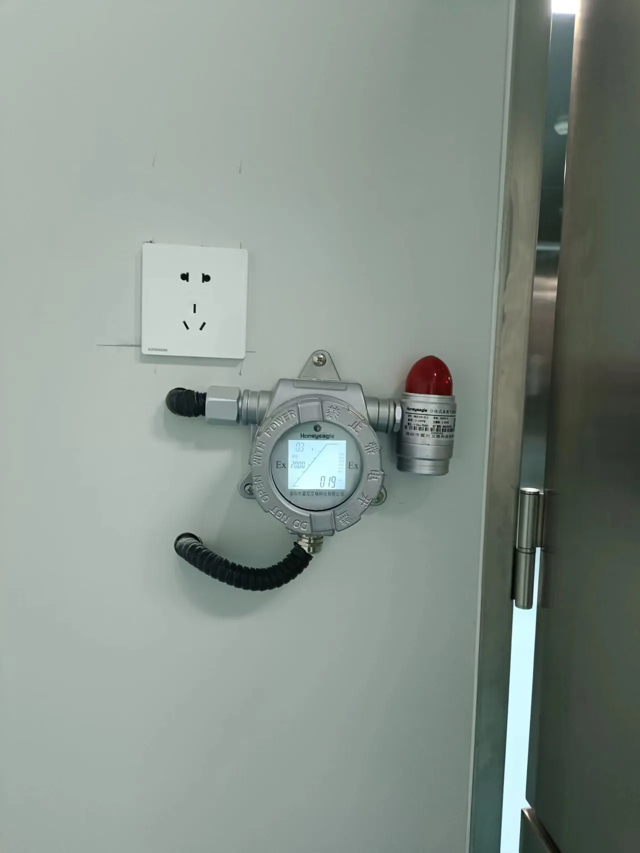 Wall mounted fixed gas detector installed in an industrial indoor environment